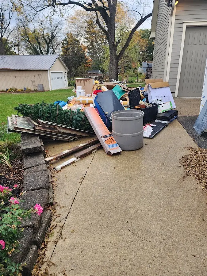 Dumpster being loaded with debris for Estate Cleanout Dumpster Rental in Cedar Hills